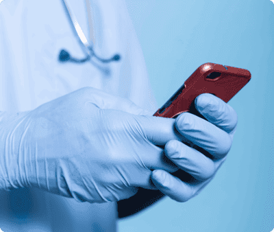 Doctor in gloves using a smartphone
